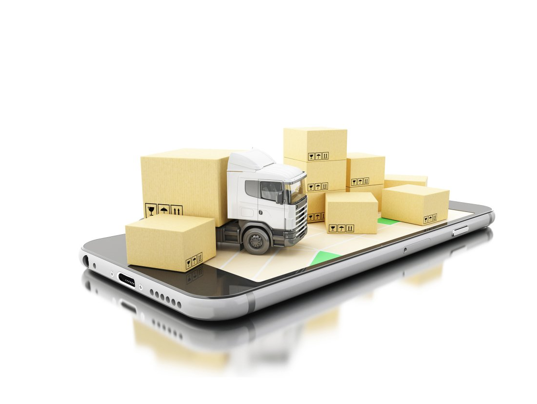 A truck is sitting on top of a cell phone surrounded by boxes.
