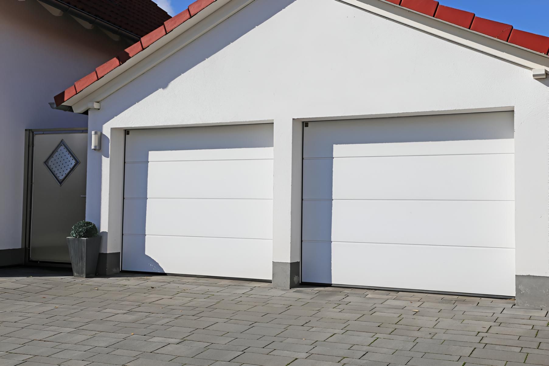 White House With Two Garage Doors and a Brick Driveway — Automated Garage Doors in Deebing Heights, QLD