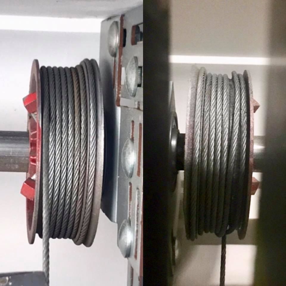 Two garage door cable drums with coiled steel cables. — Automated Garage Doors in Deebing Heights, QLD