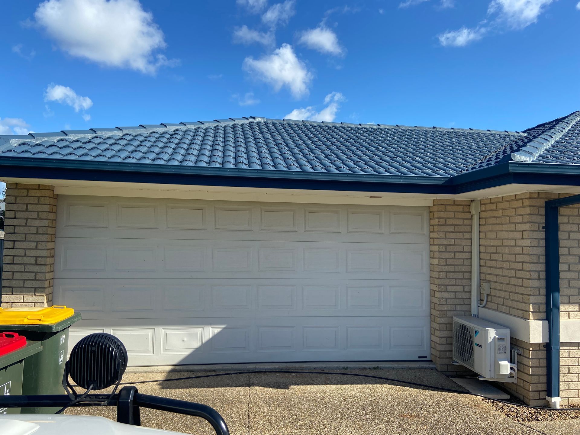Garage with a white door, unfinished ceiling, and construction materials on the floor. — Automated Garage Doors in Deebing Heights, QLD