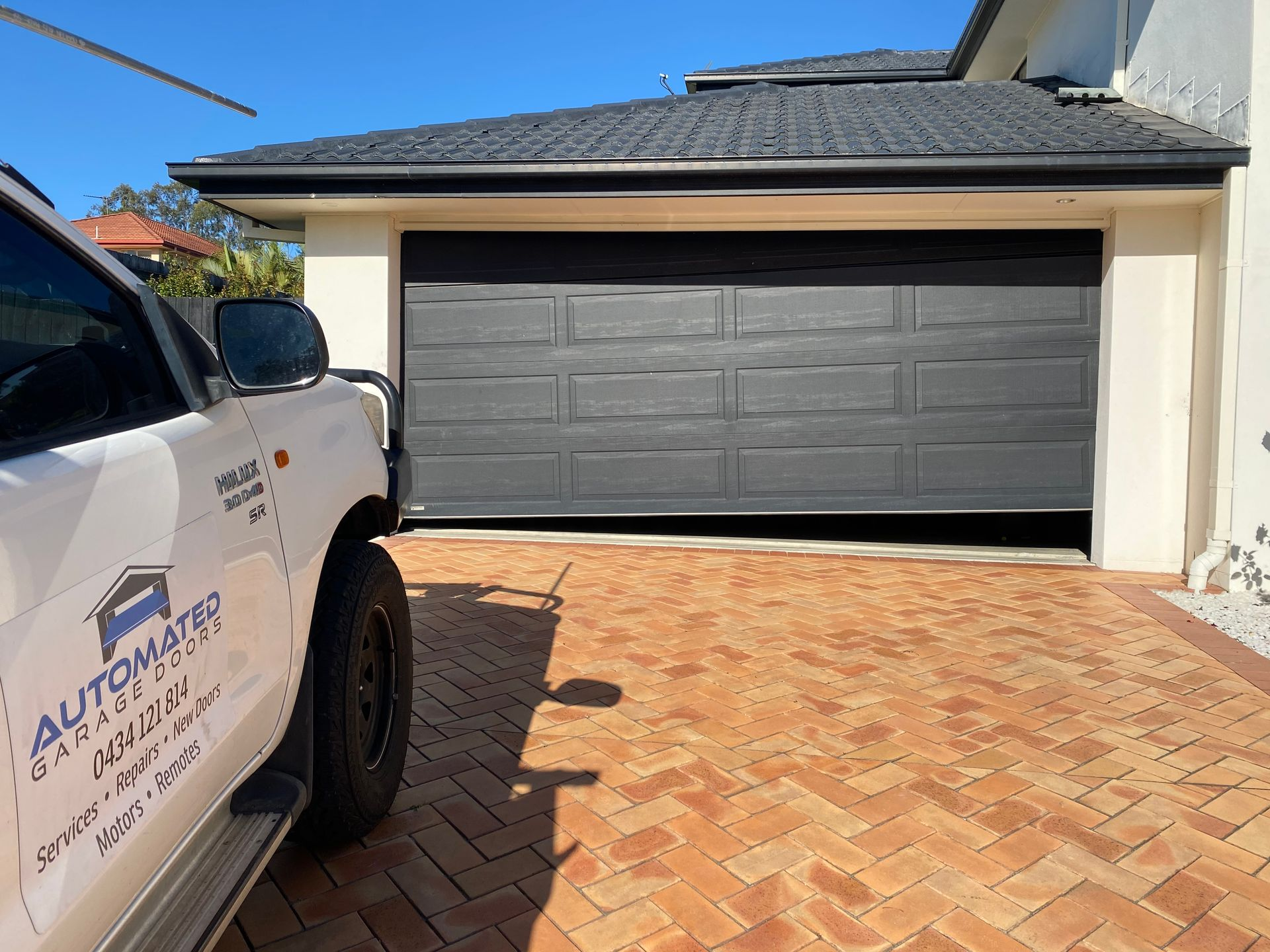 Man Repairing Garage Door Motor Placement — Automated Garage Doors in Chuwar, QLD