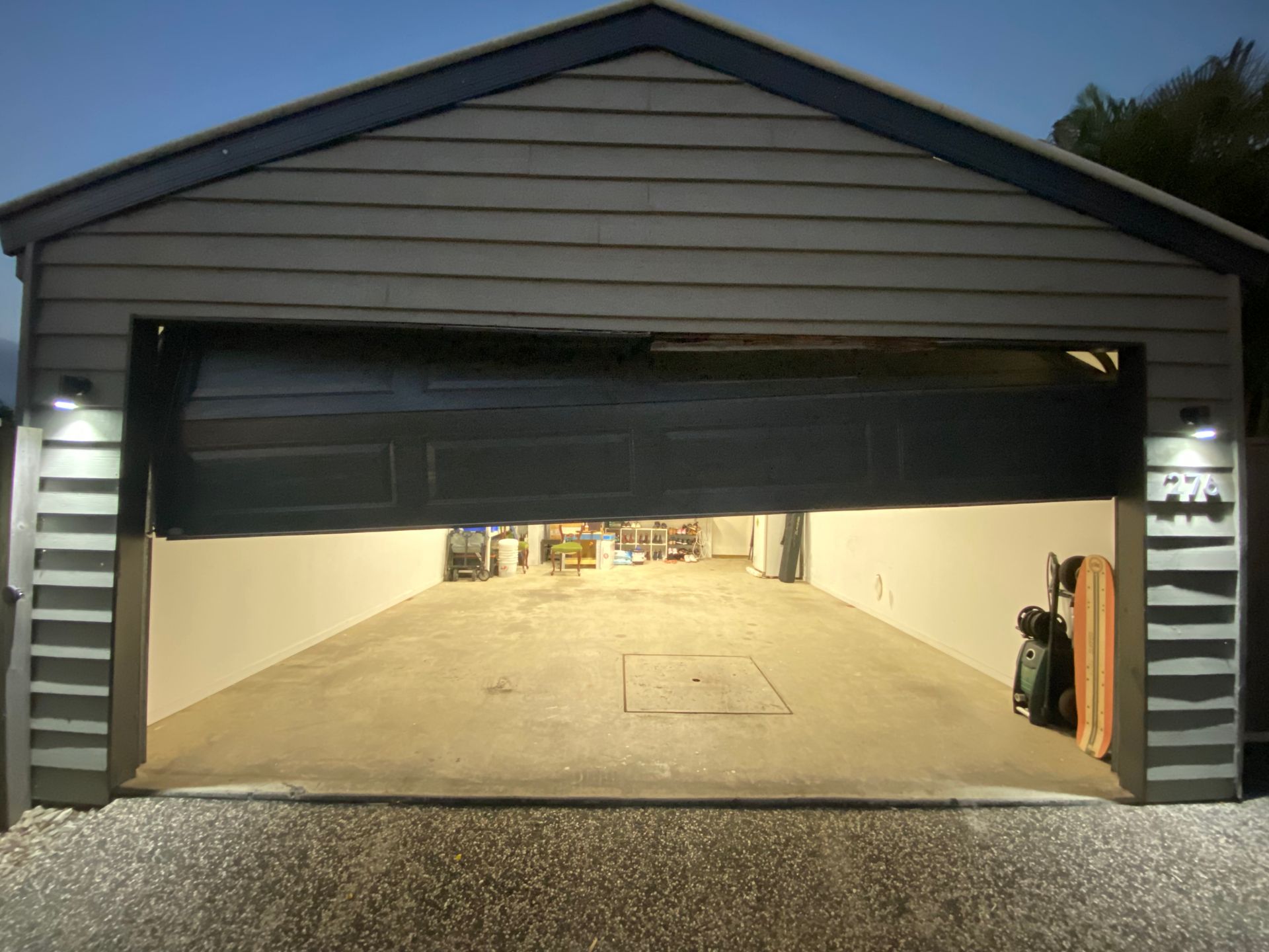 House With Two Garage Doors and a Blue Roof — Automated Garage Doors in Ipswich, QLD