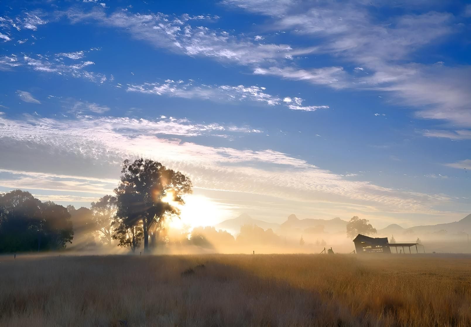 Sun is Shining Through the Clouds Over a Field — Automated Garage Doors in Yamanto, QLD