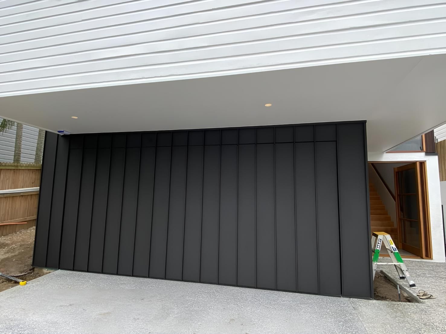 White Clean House With Garage Doors — Automated Garage Doors in Chuwar, QLD