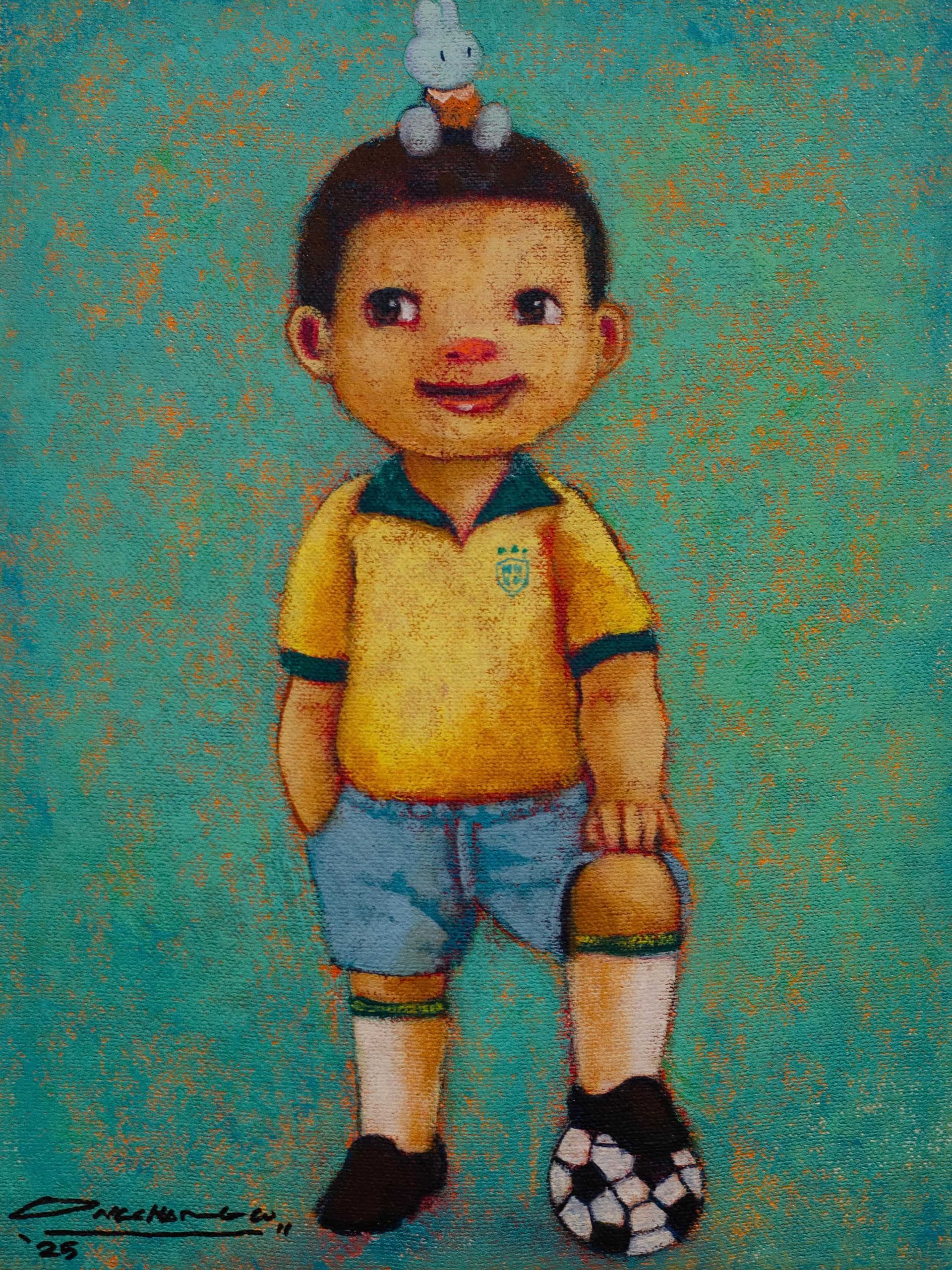 Boy in yellow soccer jersey, holding a soccer ball, with a small bunny figure on his head.