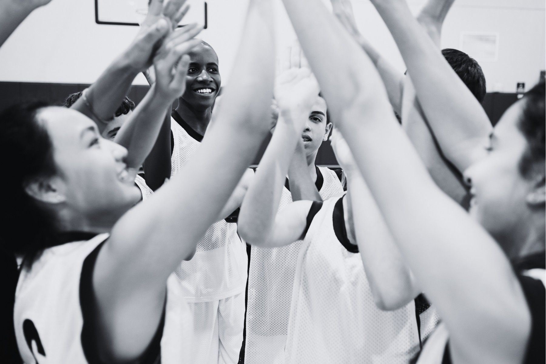 A group of basketball players are giving each other a high five
