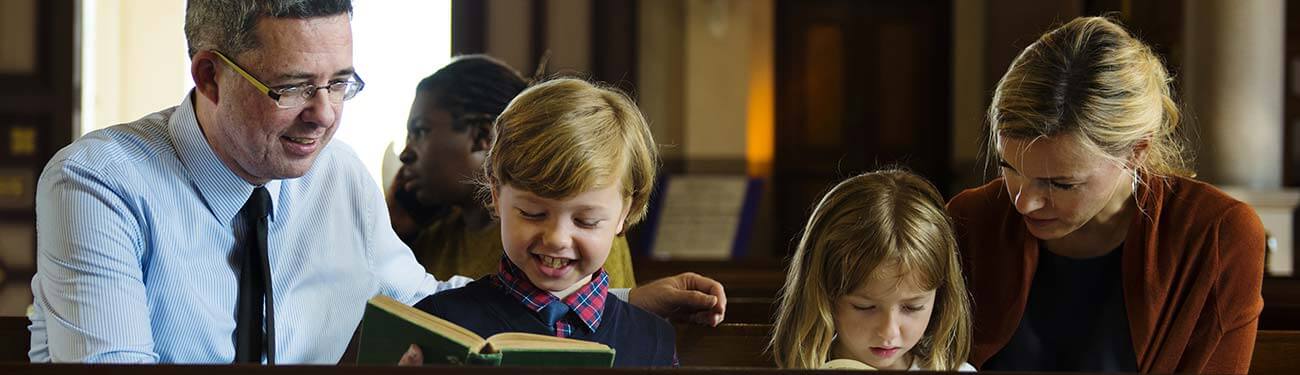 father and son reading Bible in church