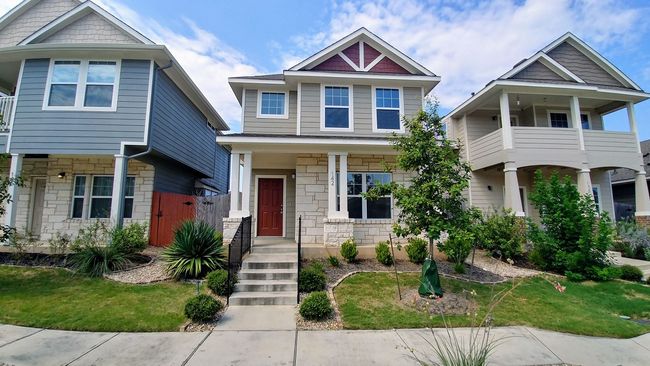 Several newly constructed homes with nice yards and a sidewalk out front.
