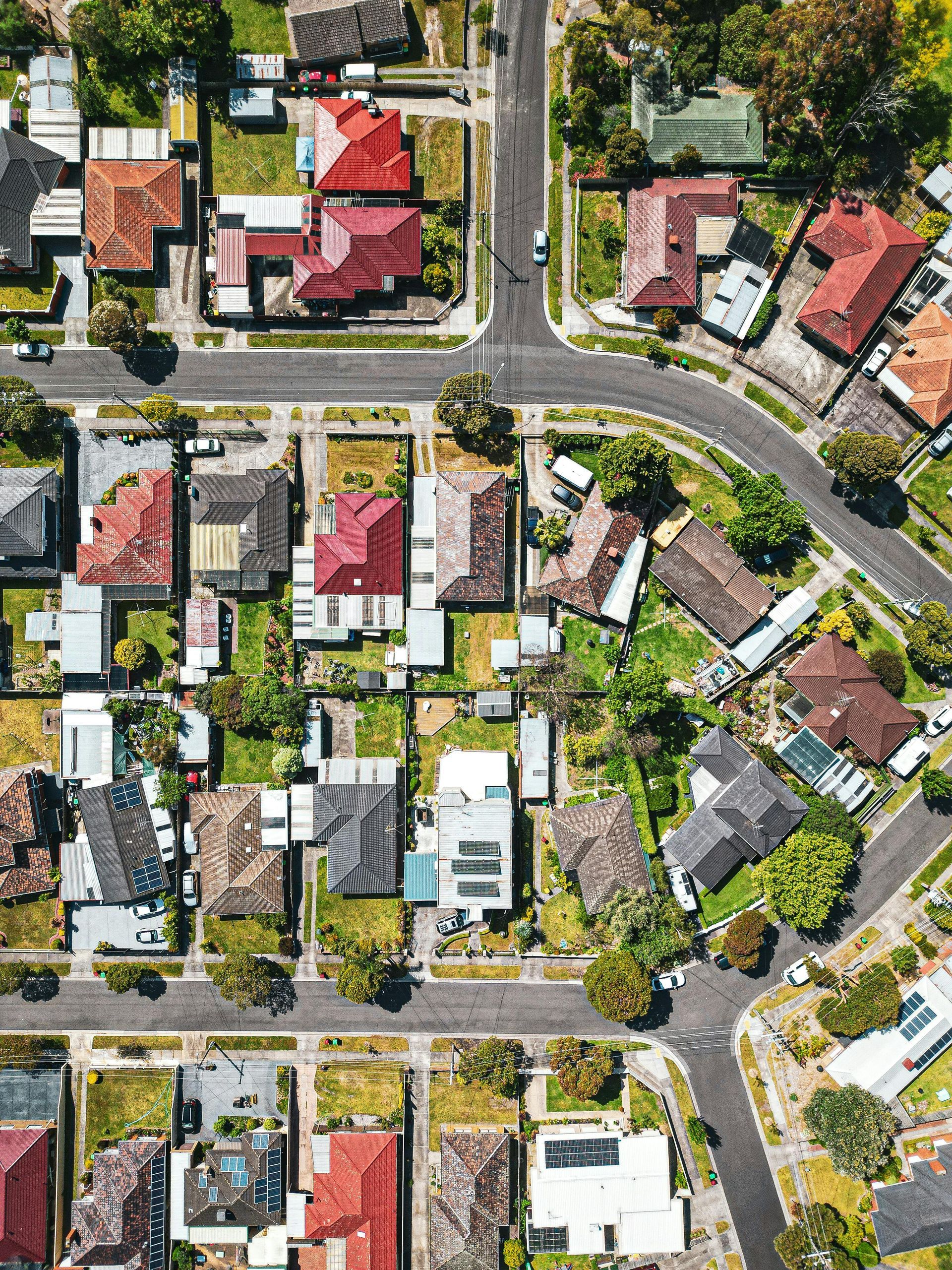 Aerial view of a suburban neighborhood with houses, streets, and trees.