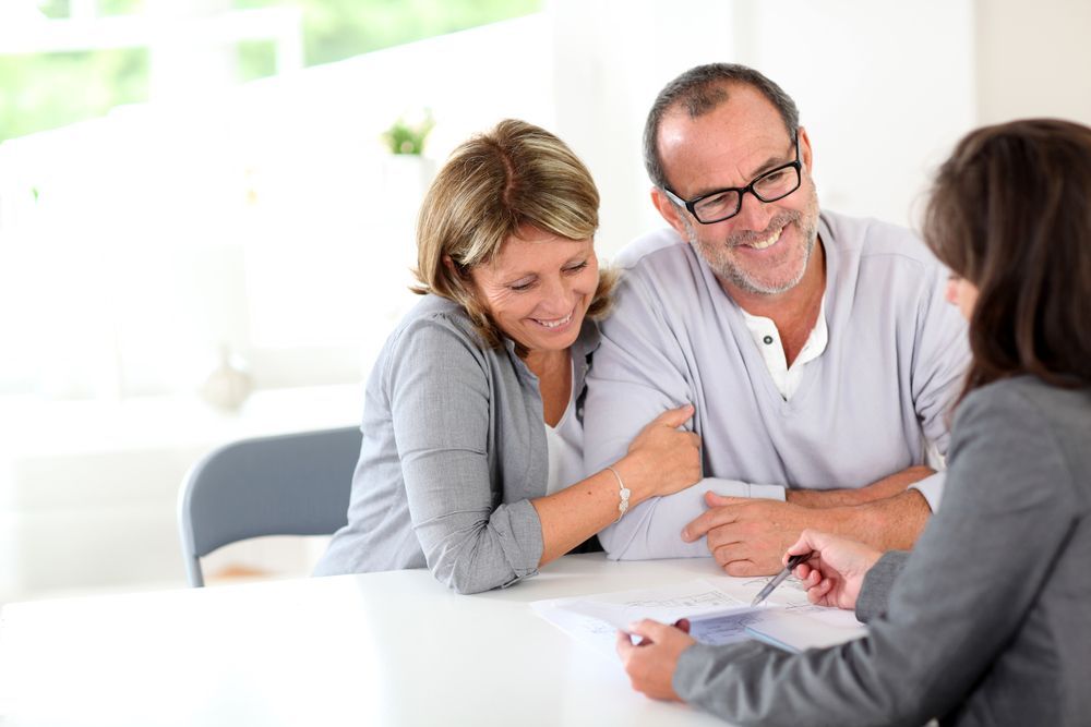 Couple with Financial Advisor Reviewing Documents — Freedom Wealth Solutions in Leongatha, VIC