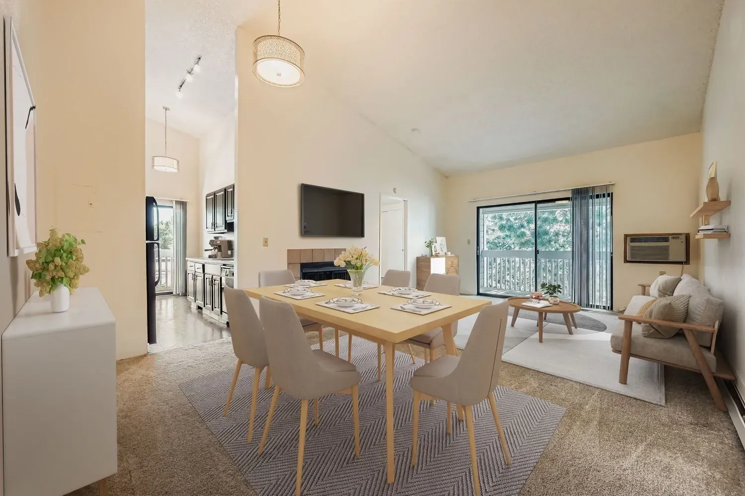 Dining area and living room with a large sliding glass door and balcony.