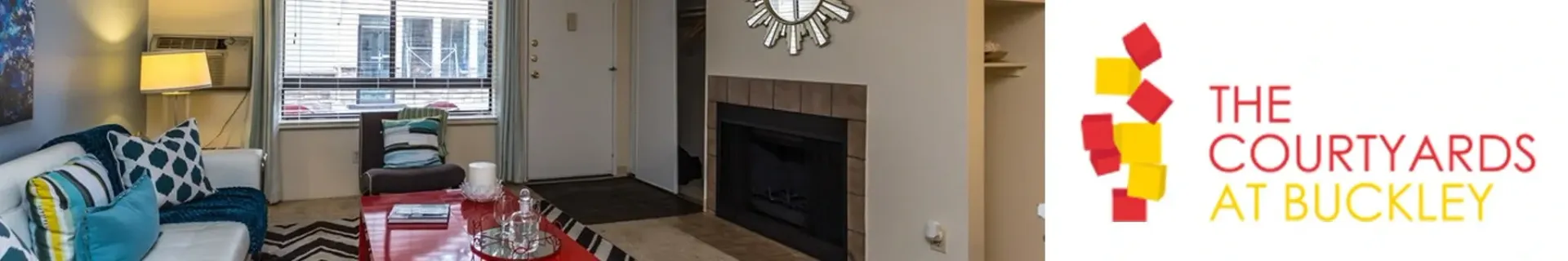 Living room with a fireplace and the property logo.