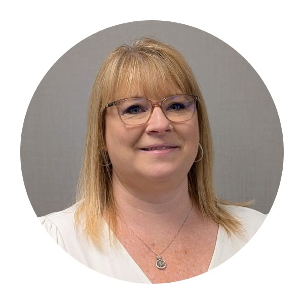 A woman wearing a blue shirt and hoop earrings is smiling in a circle.