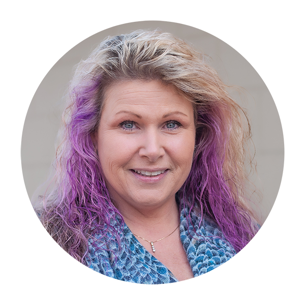 A woman with purple hair is smiling in a circle