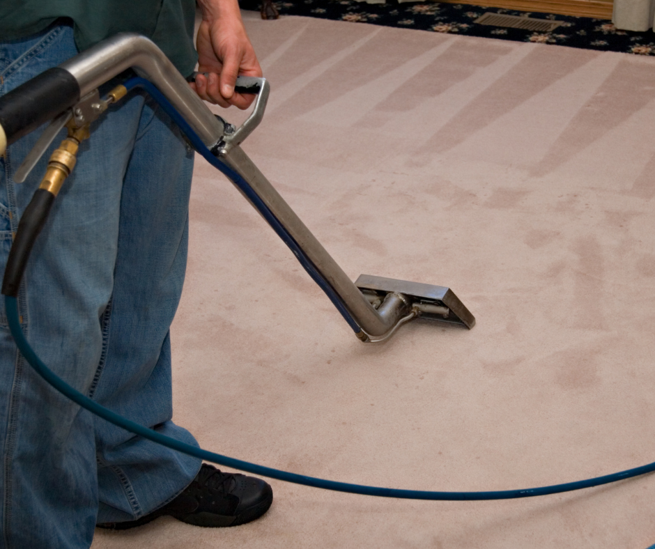 A man is using a vacuum cleaner to clean a carpet