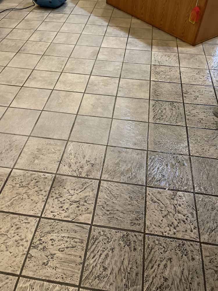 A close up of a tiled floor in a kitchen.