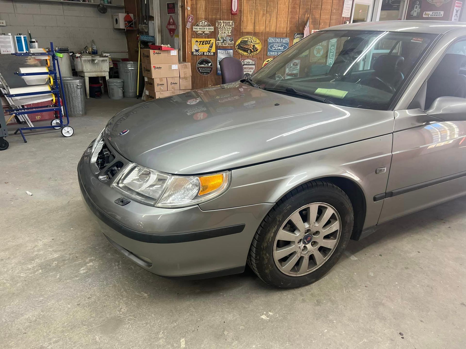 A silver car is parked in a garage.