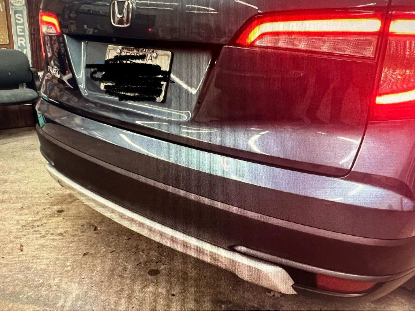 The rear bumper of a honda hr v is shown in a garage.