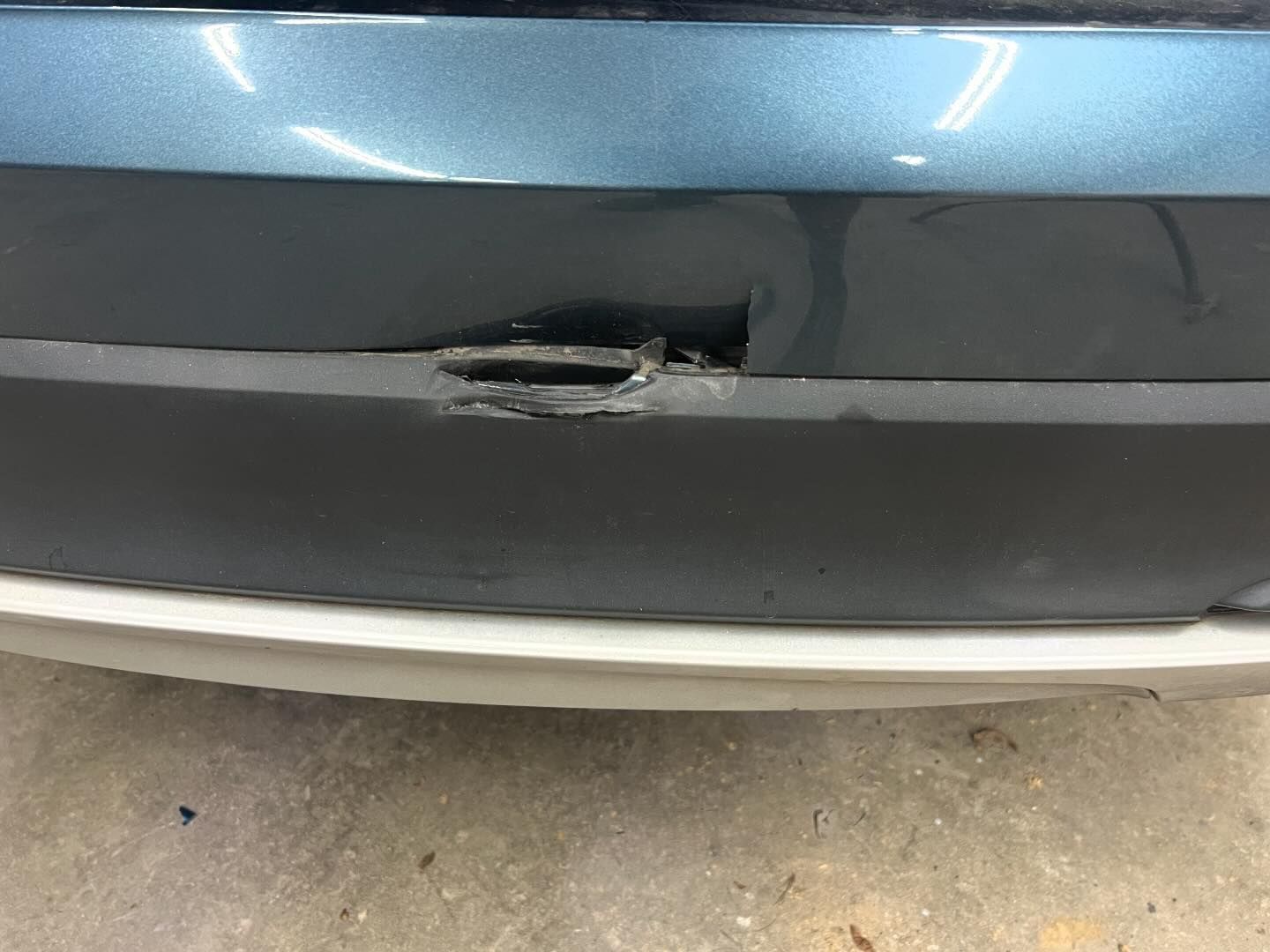 A close up of a car bumper with a hole in it.