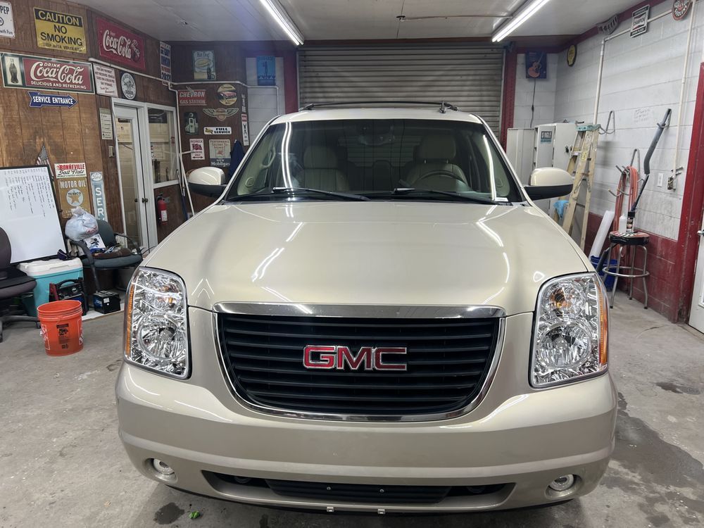 A gmc suv is parked in a garage.