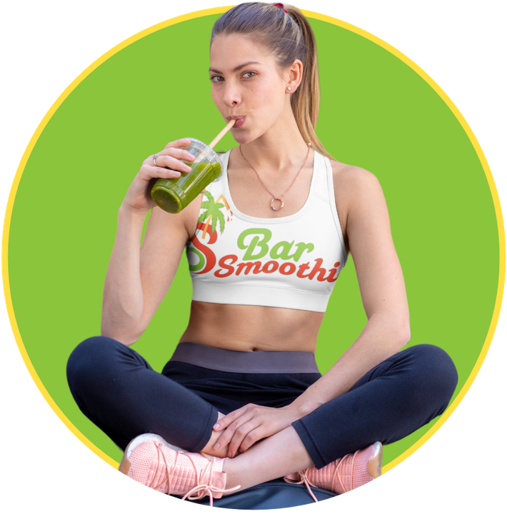 a woman is drinking a green smoothie from a cup