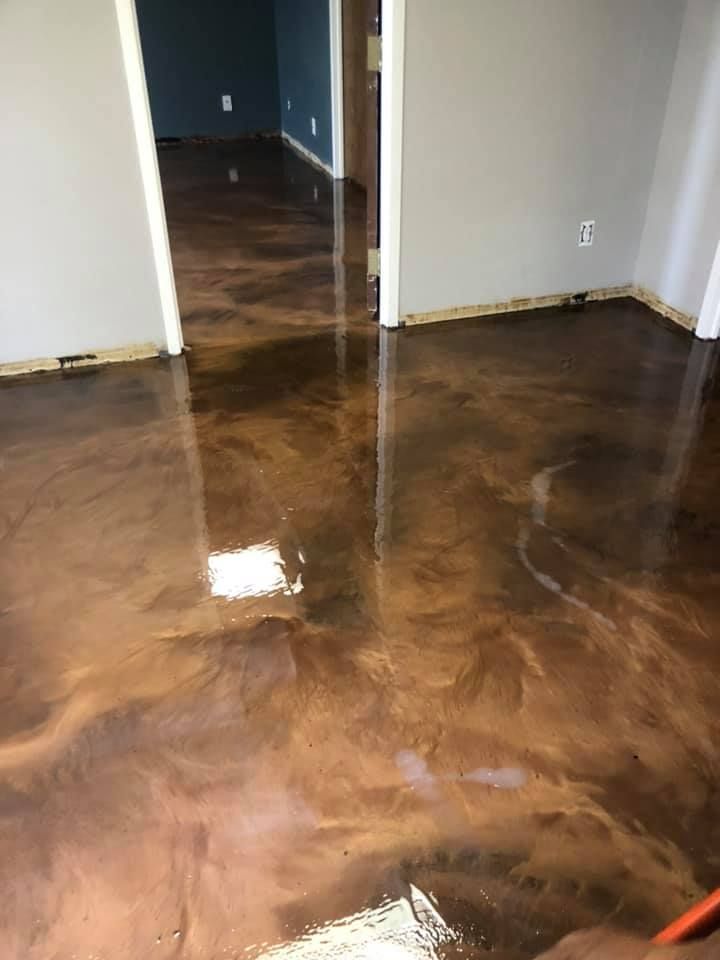 Metallic copper epoxy flooring in a home, reflecting light.