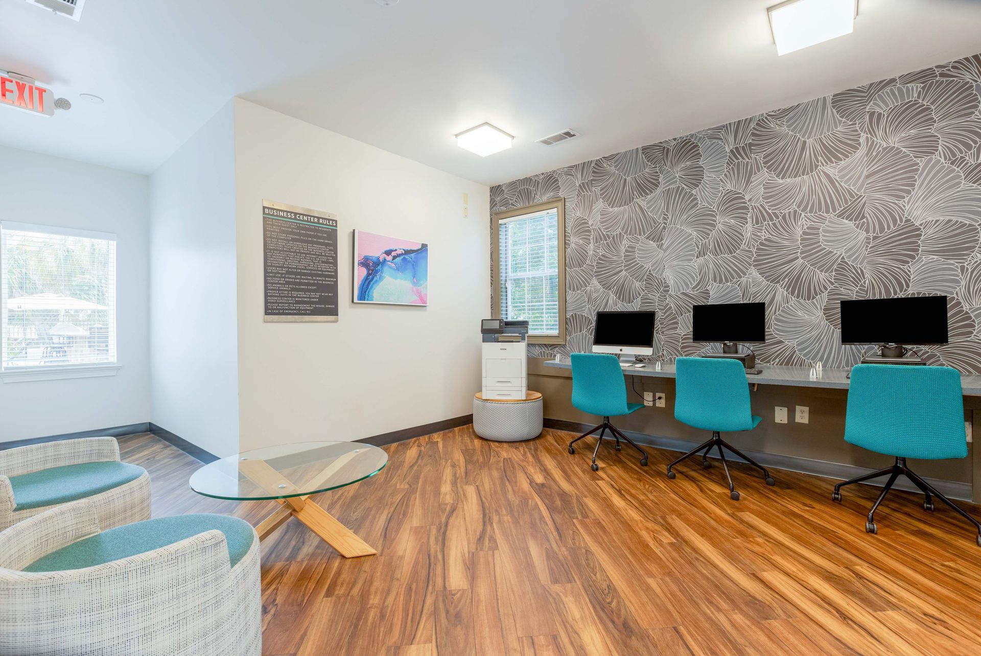 Computer lab with multiple computers and colorful chairs.