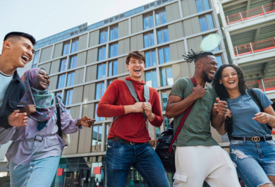 A group of students are standing in front of a building.