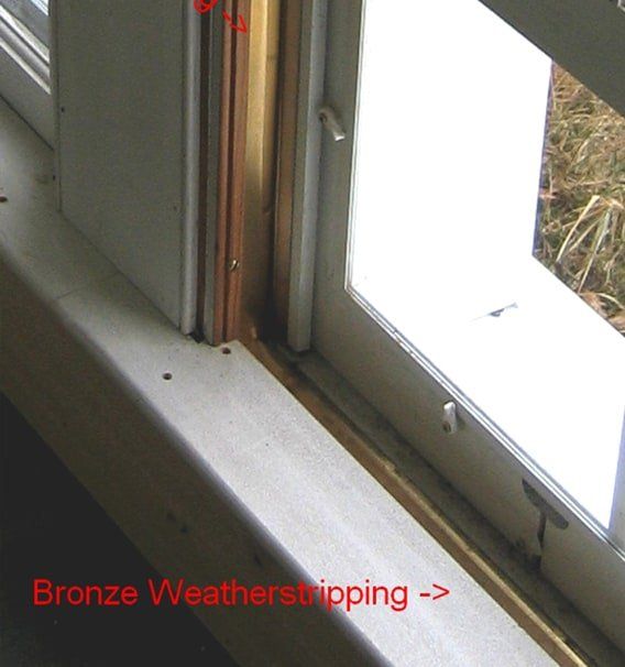 A picture of a window with the words bronze weatherstripping below it