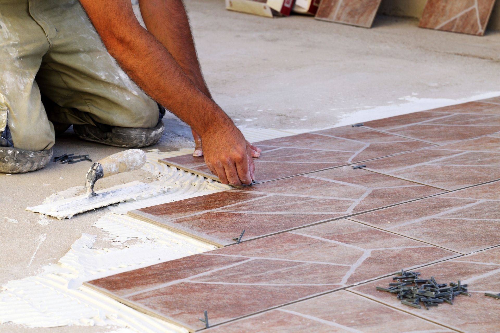 A man is holding a hammer in a construction site.