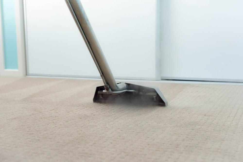 A Vacuum Cleaner is Cleaning a Carpet in a Room — Great Lakes Carpet Cleaning & Restoration In Mid North Coast, NSW