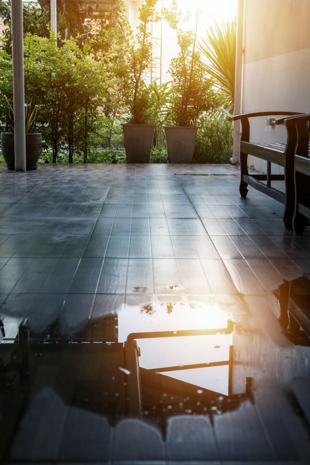 A Puddle of Water on the Floor of a Patio — Great Lakes Carpet Cleaning & Restoration In Forster, NSW