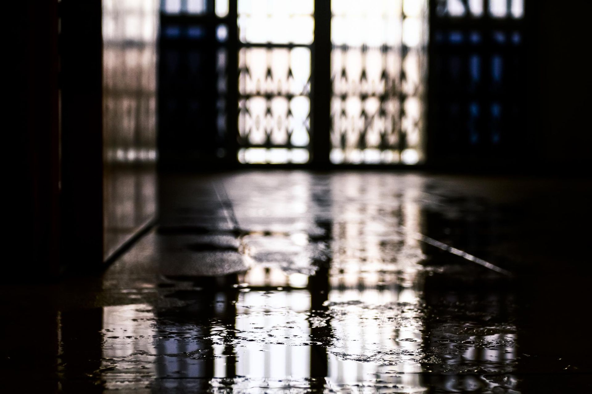 A Dark Room With a Reflection of a Window in the Floor — Great Lakes Taree Carpet Cleaning In Port Macquarie, NSW