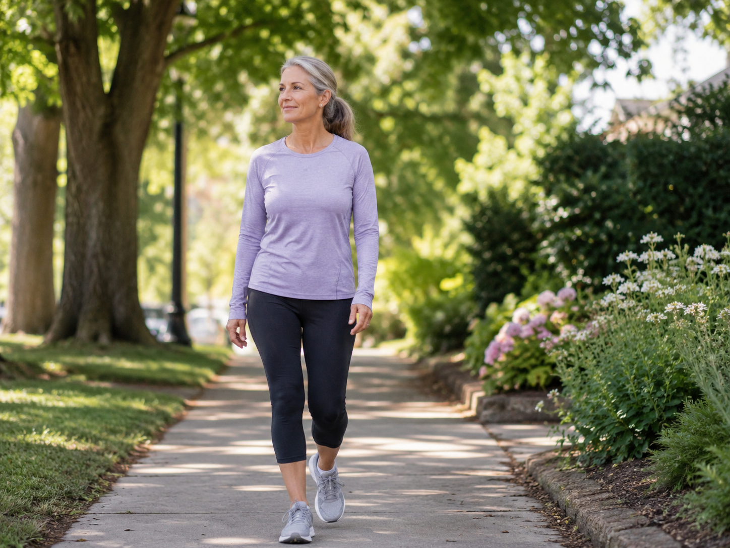 Woman walking outdoors on a shaded path for low-impact stress relief.