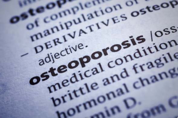 Dictionary close-up showing the word 'osteoporosis' highlighted, with a definition pertaining to bone density loss.