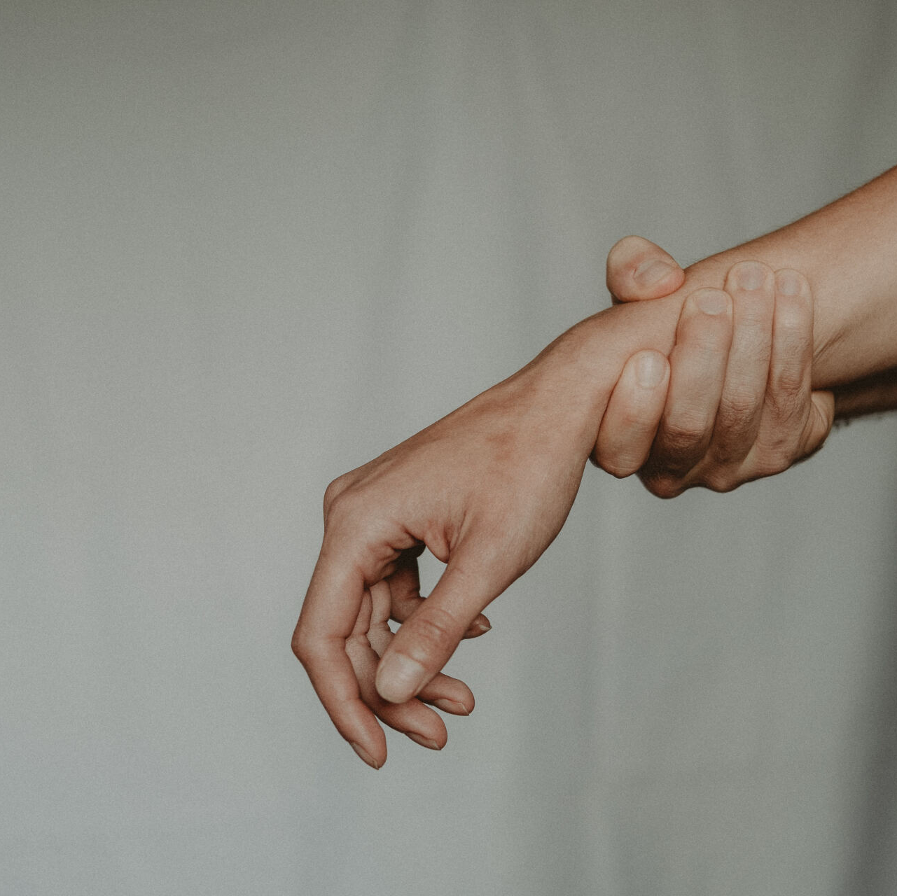 A close-up image of a person's wrist, highlighting weak wrist flexor muscles that may lead to pain and discomfort in the wrist and hand.