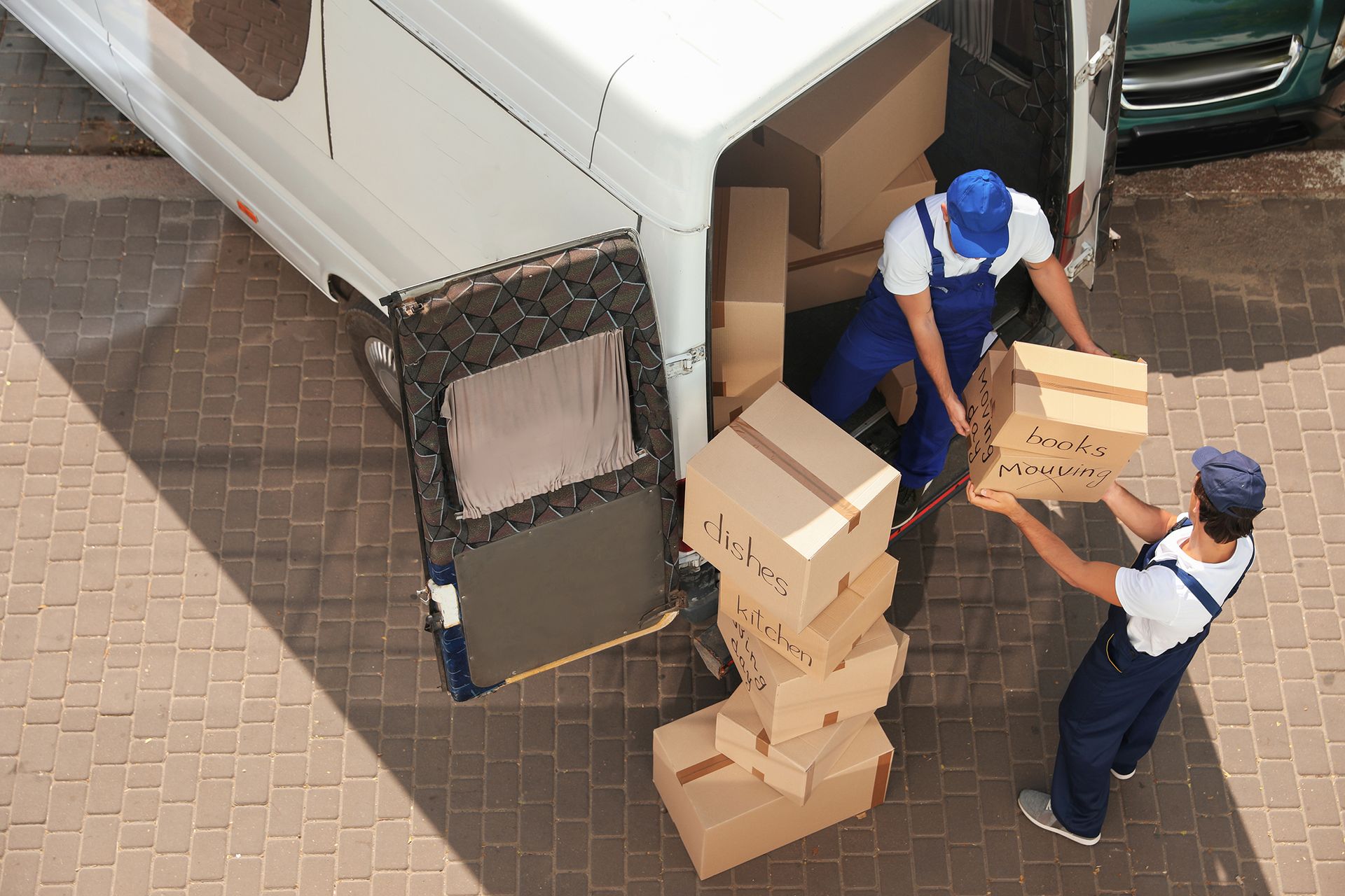 male movers unloading boxes van outdoors