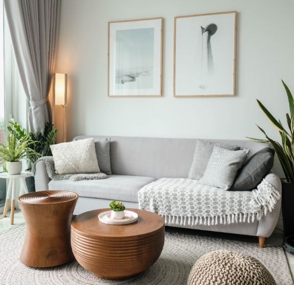 A living room with a couch and two coffee tables.