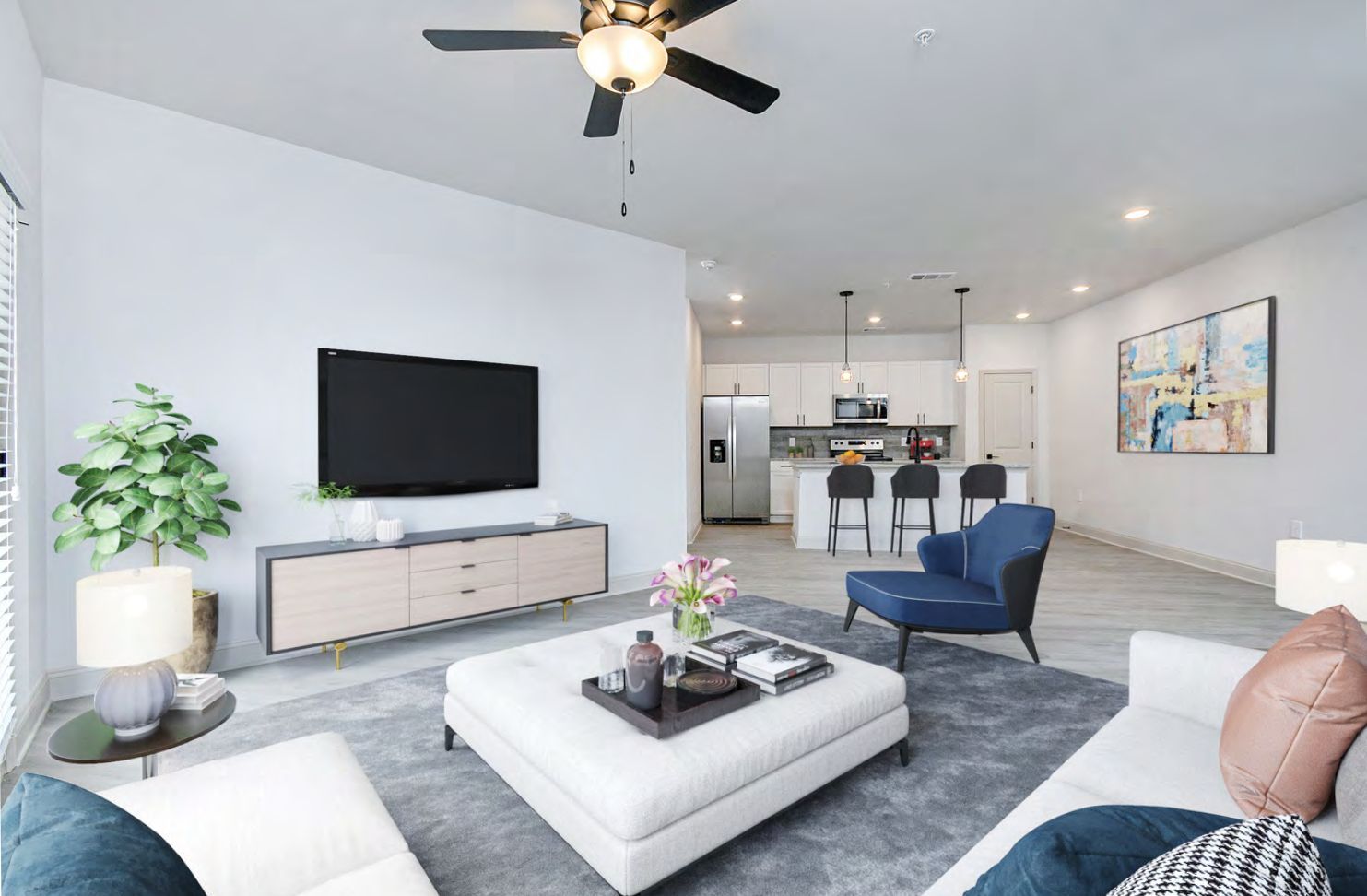 A living room with a ceiling fan and a flat-screen tv.