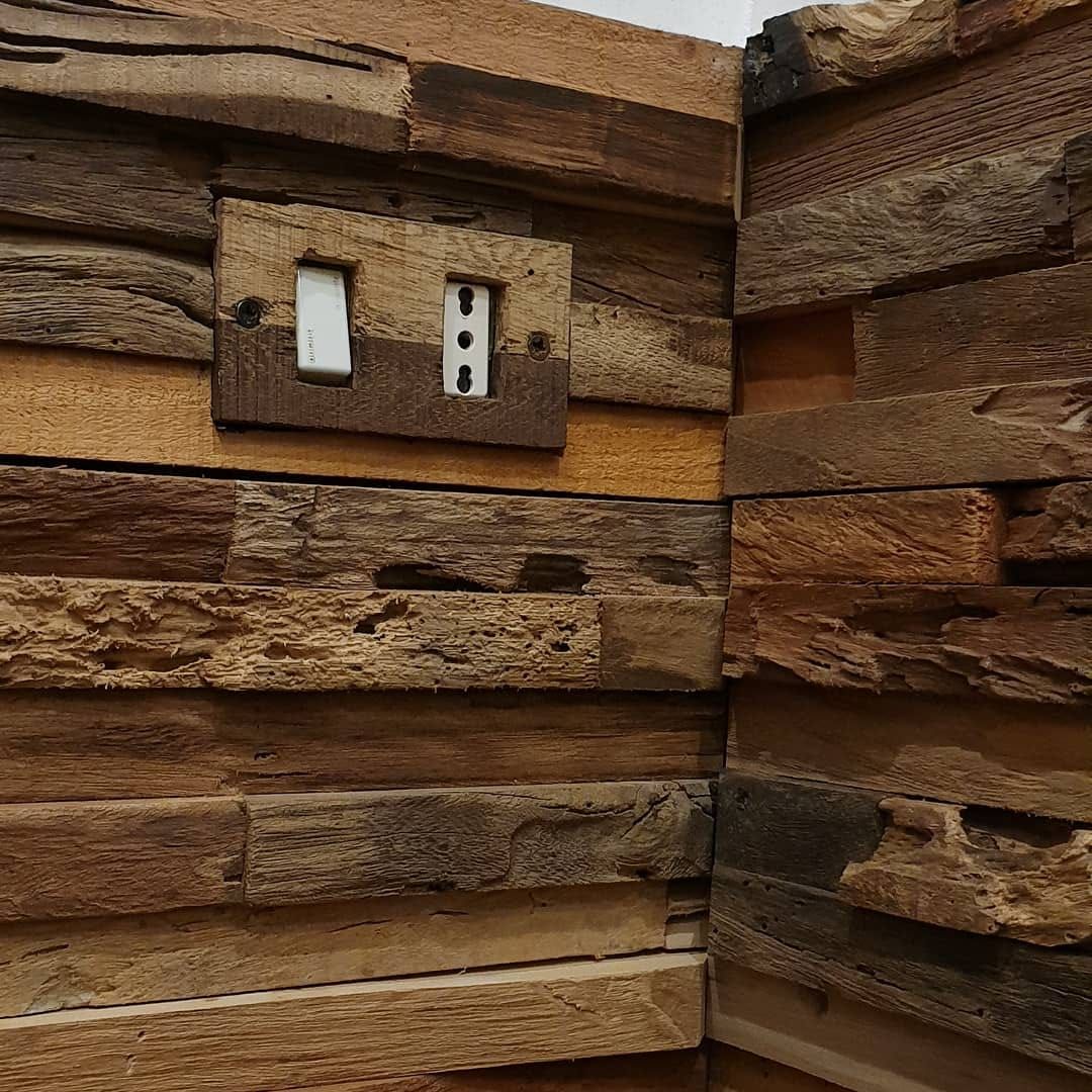 Una parete di legno con un interruttore della luce.
