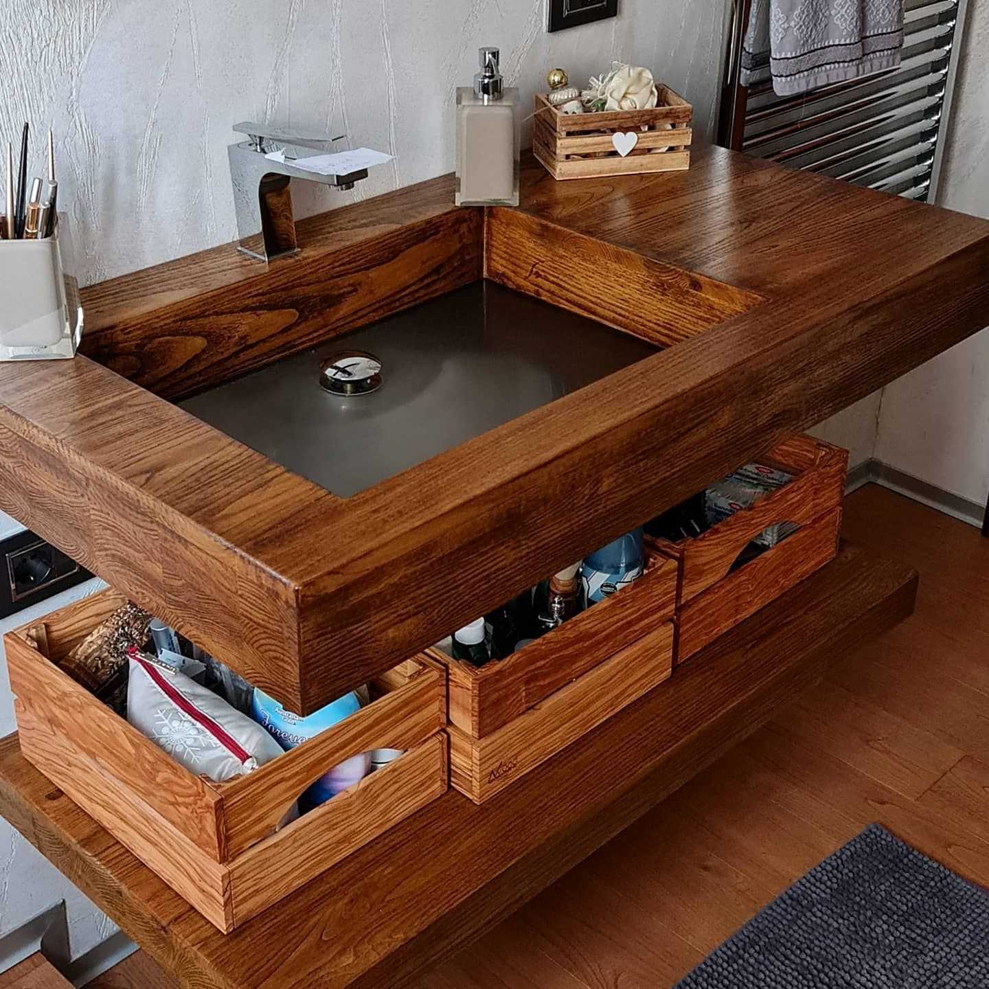 wooden sink top with drawers underneath in a bathroom