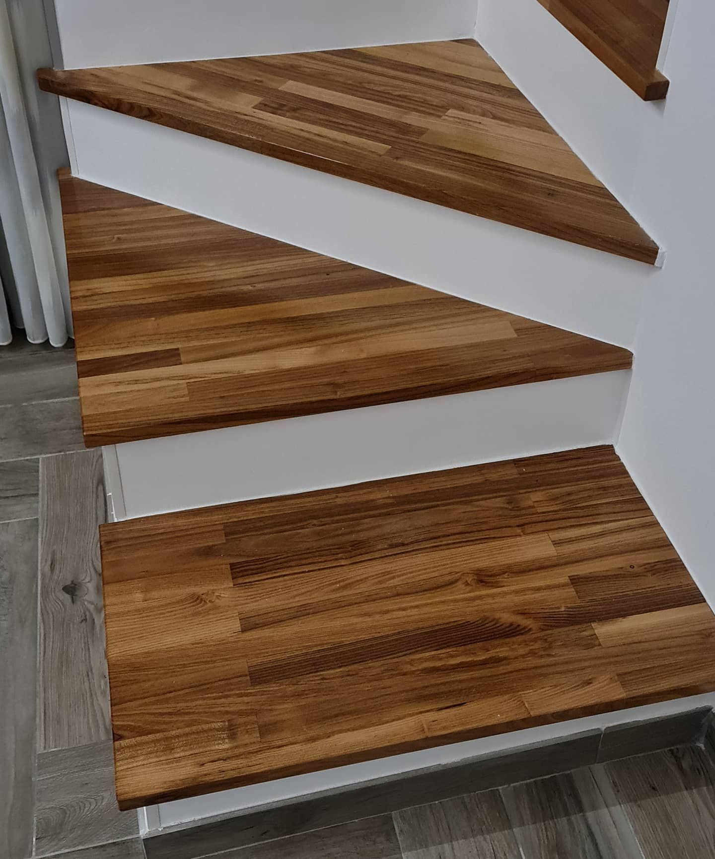 Close-up of a wooden staircase with white steps.