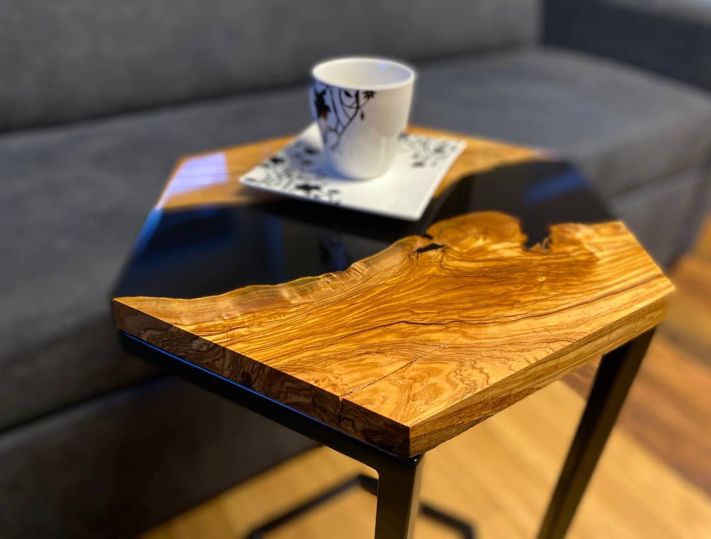 A wooden table with a cup of coffee on it in a living room.