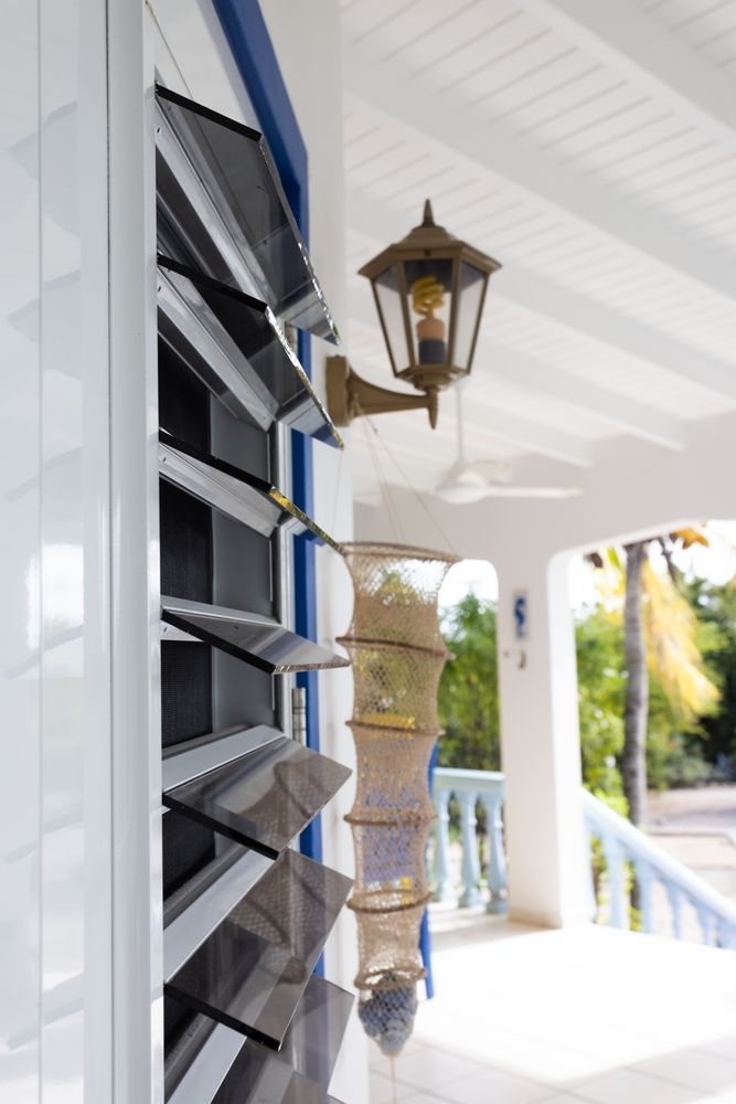 White Building Exterior With Louvered Windows — K & J Glass in Crescent Head, NSW