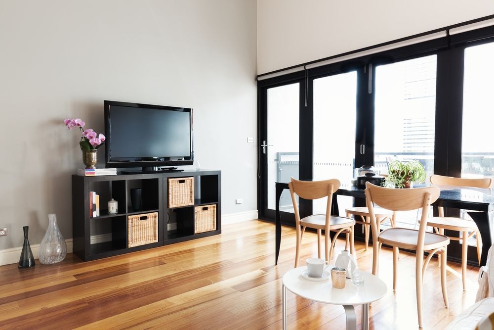 Living Room With a Black TV, Chairs, and Large Glass Doors — K & J Glass in Kempsey, NSW