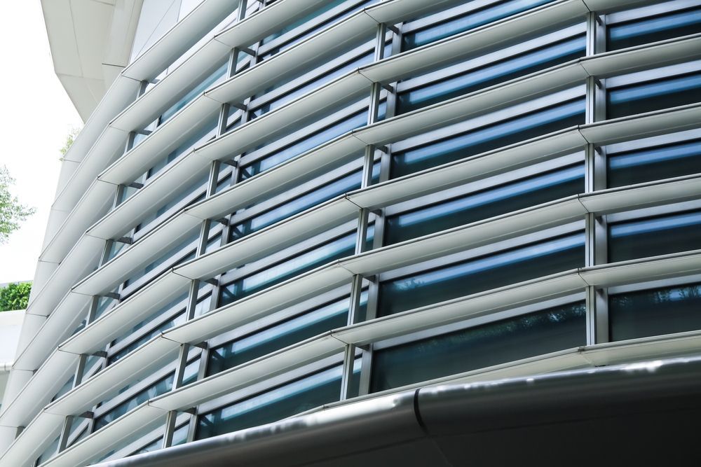 Modern Curved Building With Glass Windows — K & J Glass in Macksville, NSW