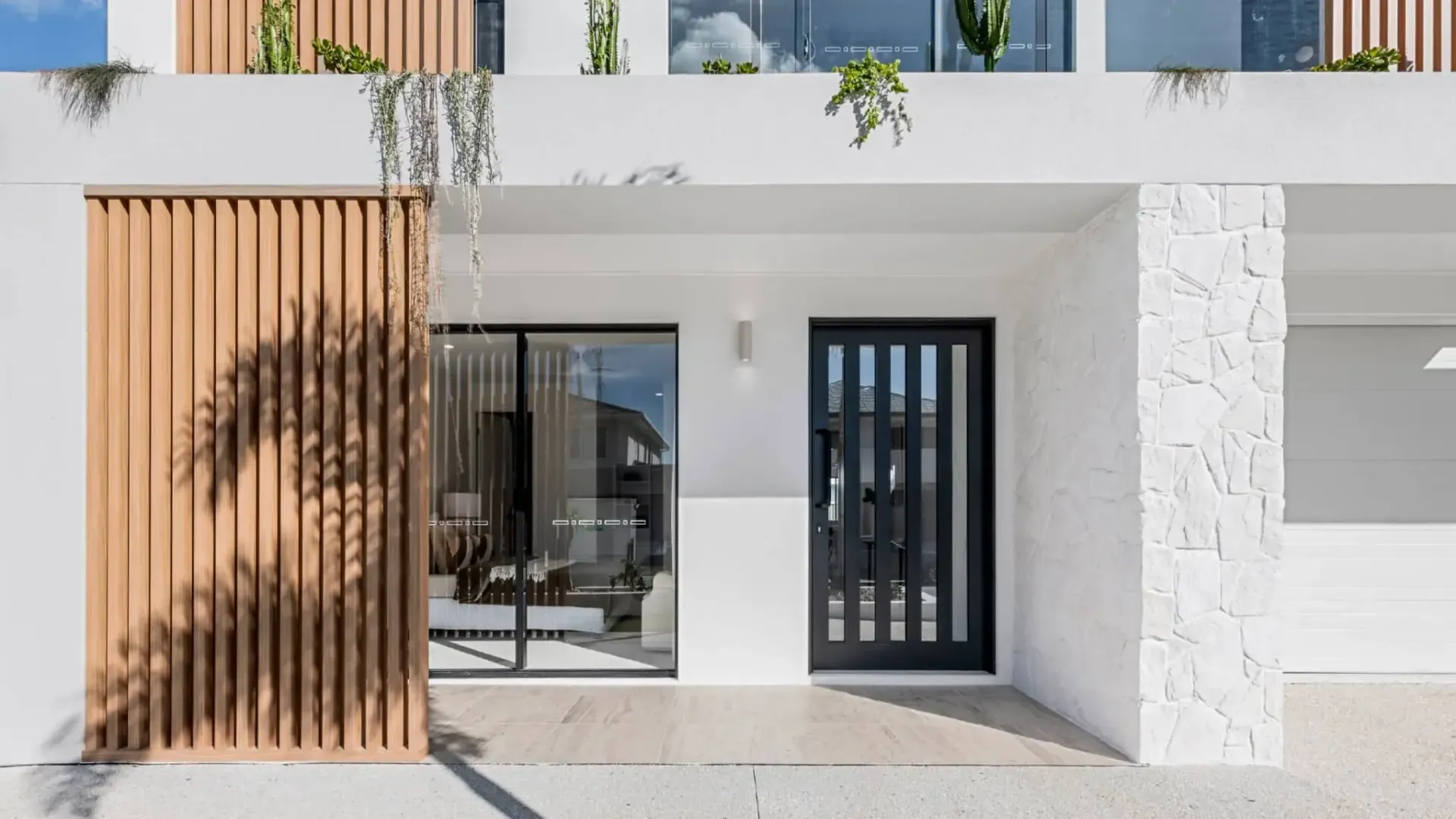 Modern white building with wooden accents and black front door — K & J Glass in Scotts Head, NSW