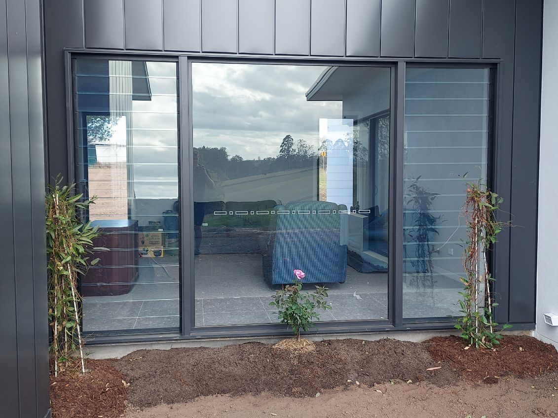 Large Black-Framed Windows Reflecting an Outdoor Scene — K & J Glass in Warrell Creek, NSW