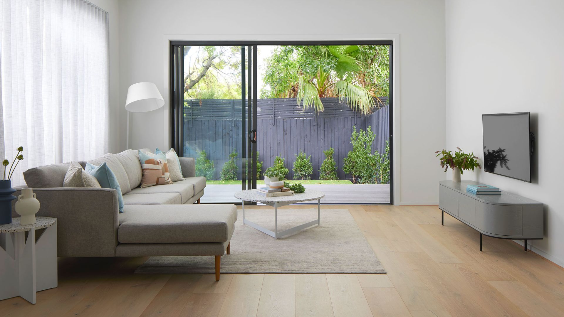 Living Room With Sofa, and Sliding Glass Doors to Backyard — K & J Glass in Bellingen, NSW
