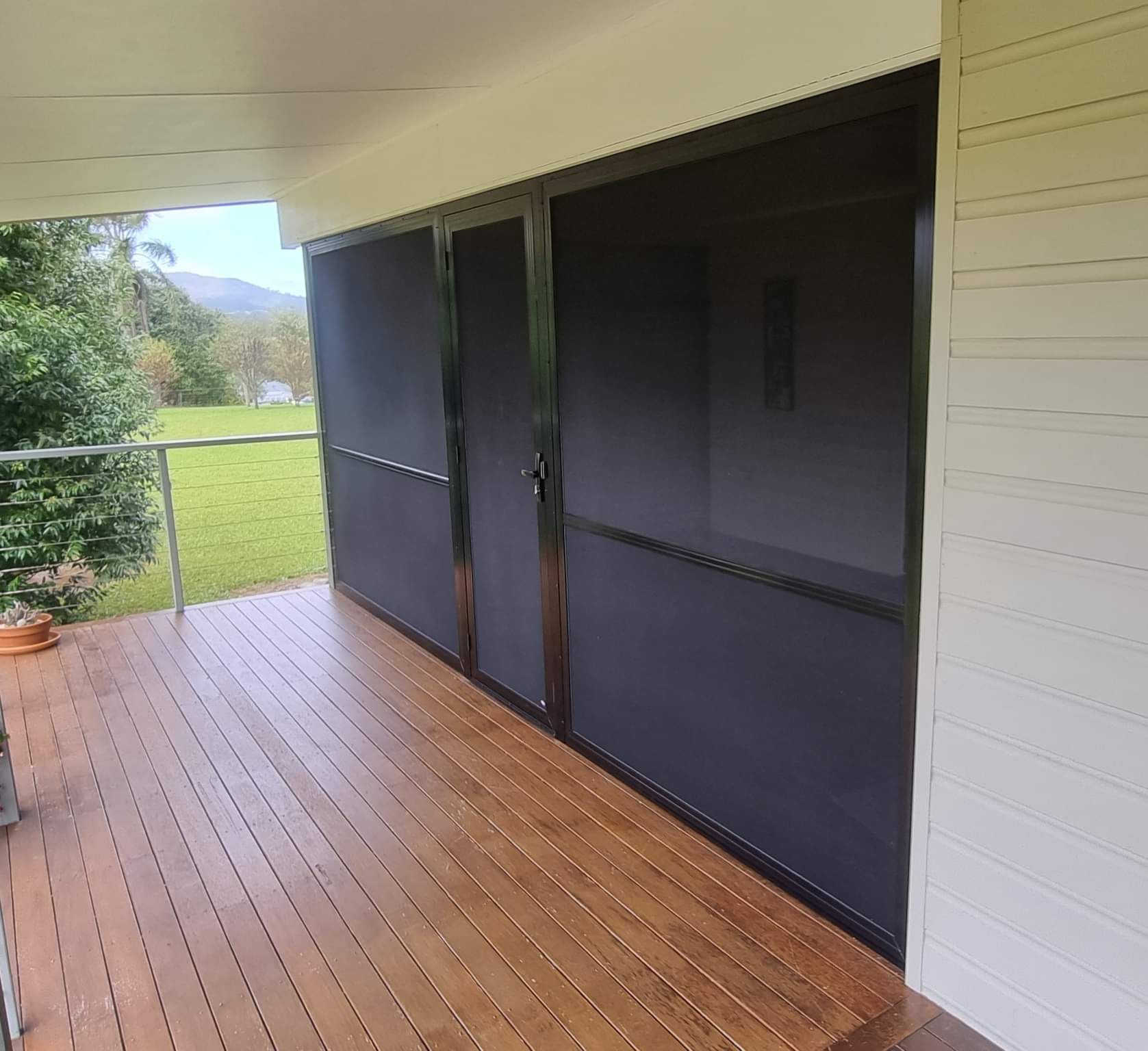 Screened Sliding Doors on a Wooden Deck — K & J Glass in Macksville, NSW